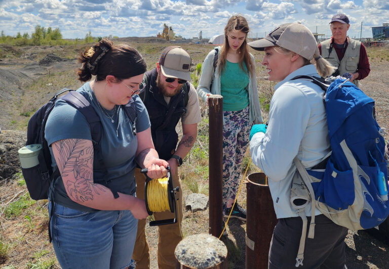 Student researchers testing a well on a rural property.