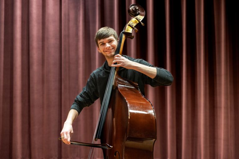 Cole Featherstone playing the upright bass.