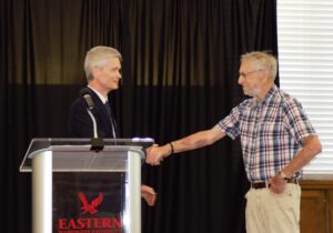 Dean Brian Donahue shakes hands with Henry-York Steiner